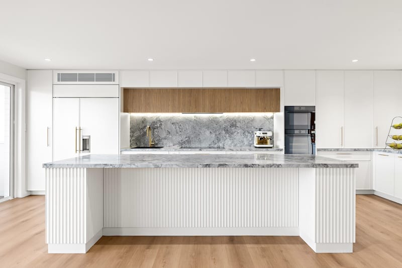 Transform your home with a luxury kitchen renovation by Dura Group, a trusted Sydney-based family-owned building company. Our expertise in home renovations shines through in this modern kitchen design featuring exquisite marble countertops, sleek cabinetry, and state-of-the-art appliances. With over 27 years of construction experience, Dura Group delivers time-efficient and budget-conscious projects across Sutherland Shire, Bayside, Inner West, Georges River, and Randwick. Our focus on trust and transparency ensures a seamless renovation experience, prioritizing quality and homeowner satisfaction. Upgrade your kitchen with a bespoke touch and enhance the heart of your home. Experience our tailored building solutions with a stress-free consultation. Discover the difference with Dura Group today and see how we can transform your living space into a masterpiece. Contact us for more details and start your renovation journey now!