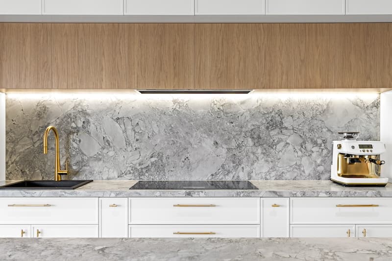 Elevate your home with Dura Group's bespoke kitchen renovations, featuring elegant marble countertops, a chic backsplash, and modern fixtures. Our Sydney-based, family-owned building company specializes in transforming kitchens, providing customized and high-quality solutions that cater to your unique style and needs. With over 27 years of experience, Managing Director Mark ensures projects are completed on time and within budget in regions such as Sutherland Shire, Bayside, and Randwick. Choose Dura Group for your kitchen upgrade to experience exceptional craftsmanship, transparency, and a homeowner-first approach. Contact us to start designing your dream kitchen today!