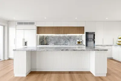 Discover a modern kitchen remodel with luxurious marble finishes. Enhance your home with Dura Group's expertise. Contact us for your renovation!