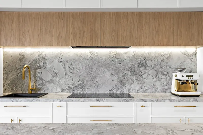 Elevate your home with Dura Group's bespoke kitchen renovations, featuring elegant marble countertops, a chic backsplash, and modern fixtures. Our Sydney-based, family-owned building company specializes in transforming kitchens, providing customized and high-quality solutions that cater to your unique style and needs. With over 27 years of experience, Managing Director Mark ensures projects are completed on time and within budget in regions such as Sutherland Shire, Bayside, and Randwick. Choose Dura Group for your kitchen upgrade to experience exceptional craftsmanship, transparency, and a homeowner-first approach. Contact us to start designing your dream kitchen today!