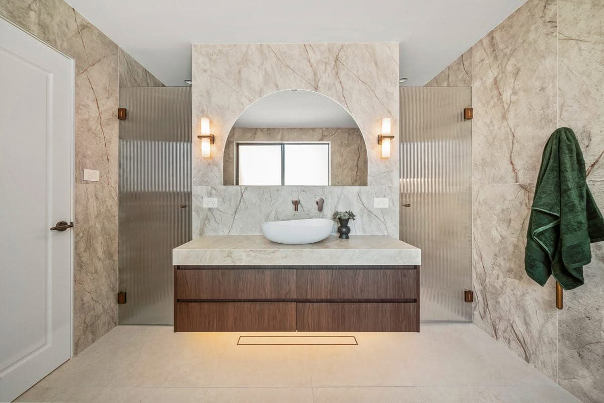 Ensuite renovation with arched alcove and timber vanity