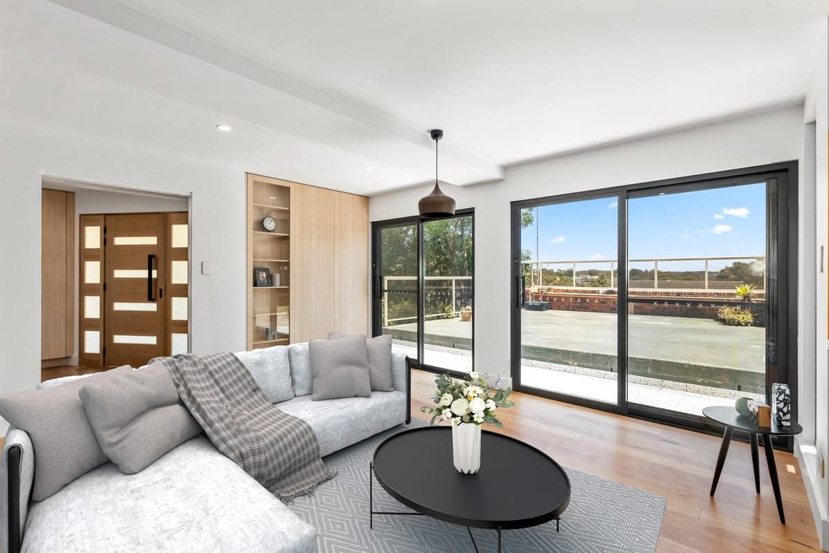 Open-plan lounge renovation with timber entry door