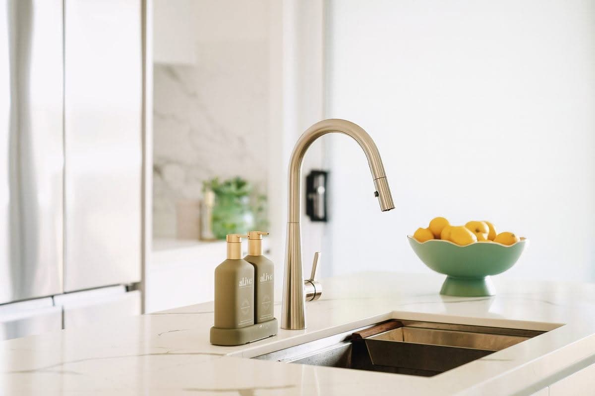 Kitchen detail with brushed gold tapware and undermount sink