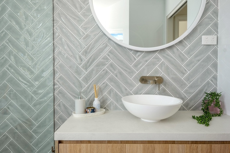 Transform your bathroom with a chic herringbone design. Discover Dura Group's tailored solutions today. Enhance style and functionality. Contact us now!
