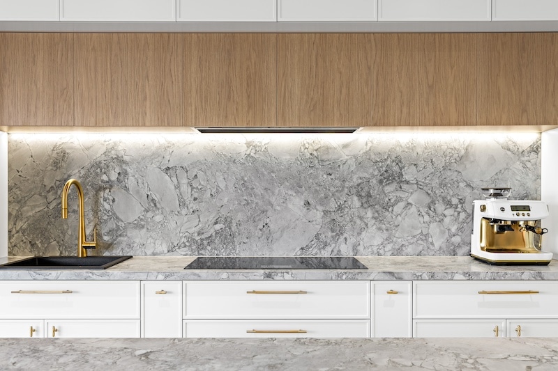 Elevate your home with Dura Group's bespoke kitchen renovations, featuring elegant marble countertops, a chic backsplash, and modern fixtures. Our Sydney-based, family-owned building company specializes in transforming kitchens, providing customized and high-quality solutions that cater to your unique style and needs. With over 27 years of experience, Managing Director Mark ensures projects are completed on time and within budget in regions such as Sutherland Shire, Bayside, and Randwick. Choose Dura Group for your kitchen upgrade to experience exceptional craftsmanship, transparency, and a homeowner-first approach. Contact us to start designing your dream kitchen today!