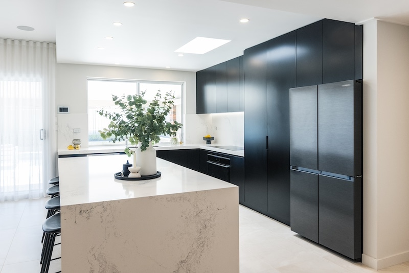 Experience the elegance of a modern kitchen renovation, expertly crafted by Dura Group, a leading Sydney-based building company. This sleek design features stylish black cabinetry and a spacious, marble-finish island, perfect for enhancing both functionality and aesthetics. At Dura Group, led by Managing Director Mark with over 27 years of construction experience, we specialize in kitchen upgrades that are time-efficient and budget-friendly. Operating in the Sutherland Shire, Bayside, Inner West, and surrounding areas, our team prioritizes homeowner satisfaction, ensuring open communication and high-quality builds. Trust us to transform your space with tailored solutions that reflect your unique style. Contact Dura Group today to start your dream kitchen project. Our expertise in home renovations guarantees a seamless experience, focused on trust, transparency, and excellence in every detail.