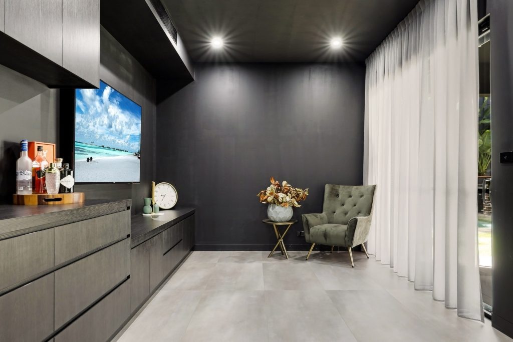 Modern living room with TV, chair, and decor elements