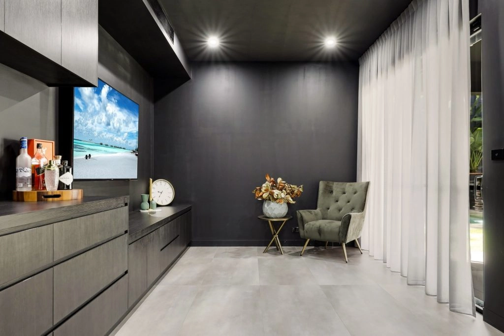 Modern living room with TV, chair, and decor elements